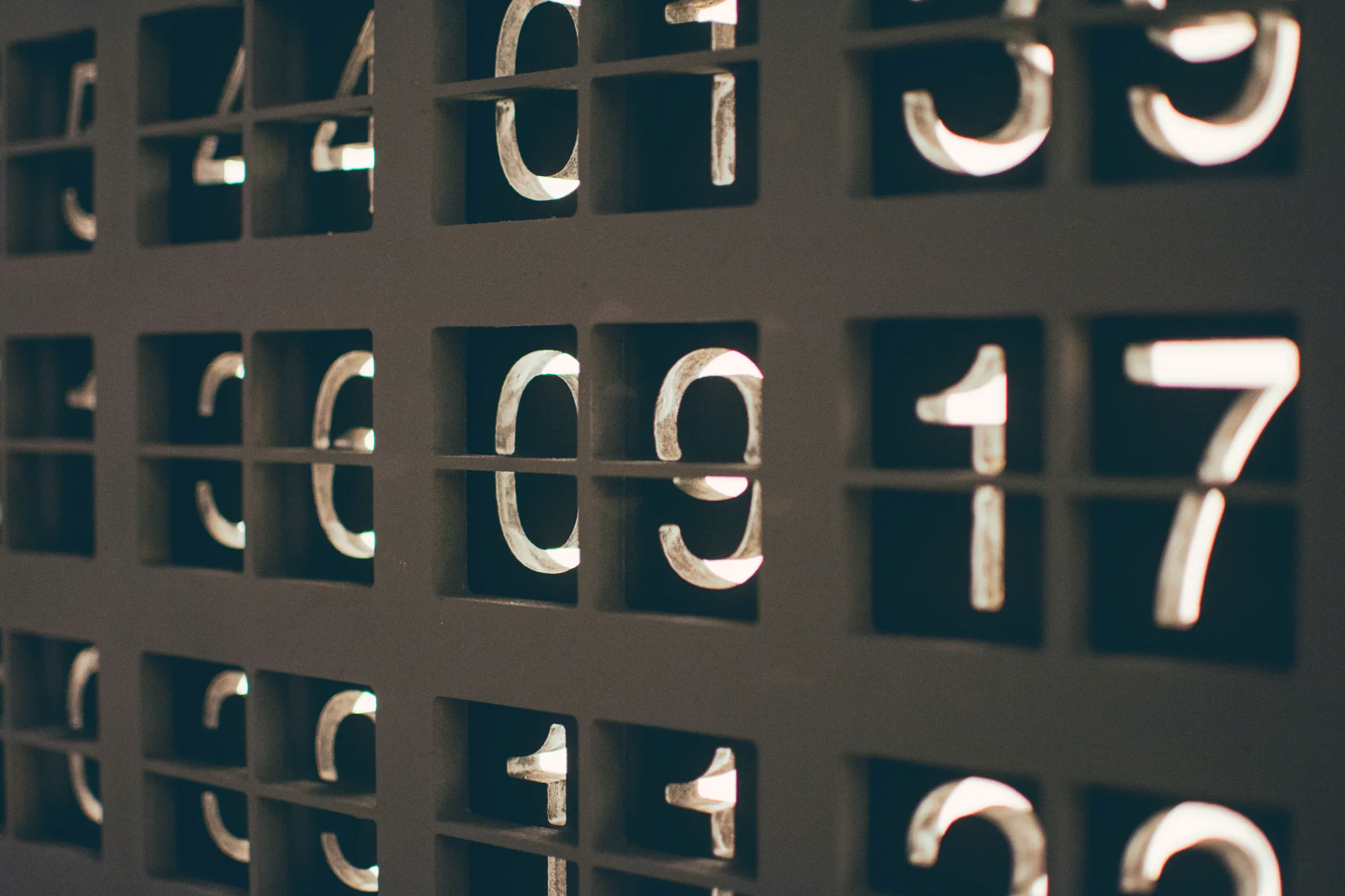 Chiffres en typographie au plomb disposés dans une grille de casiers